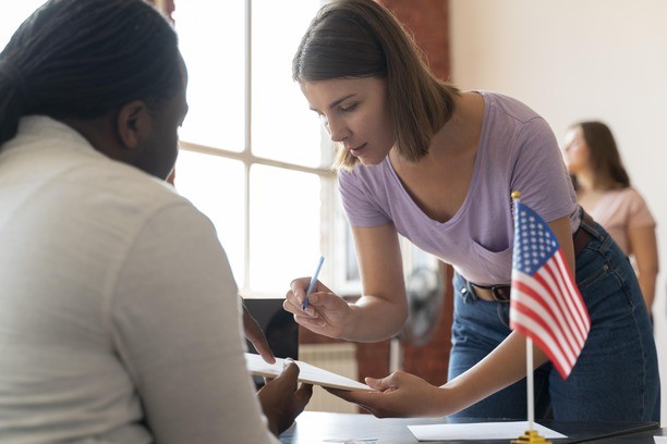 American woman signing documents for Canada immigration for Americans.