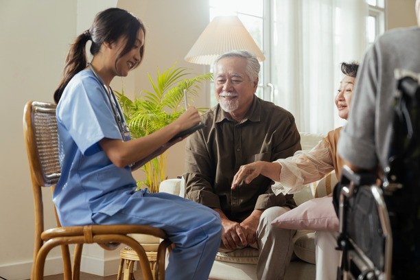 "Caregiver assisting elderly couple in Canada for caregiver jobs