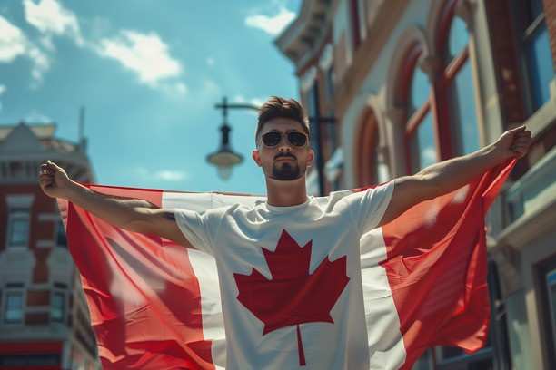 Proud man holding Canada's flag after getting Canadian PR